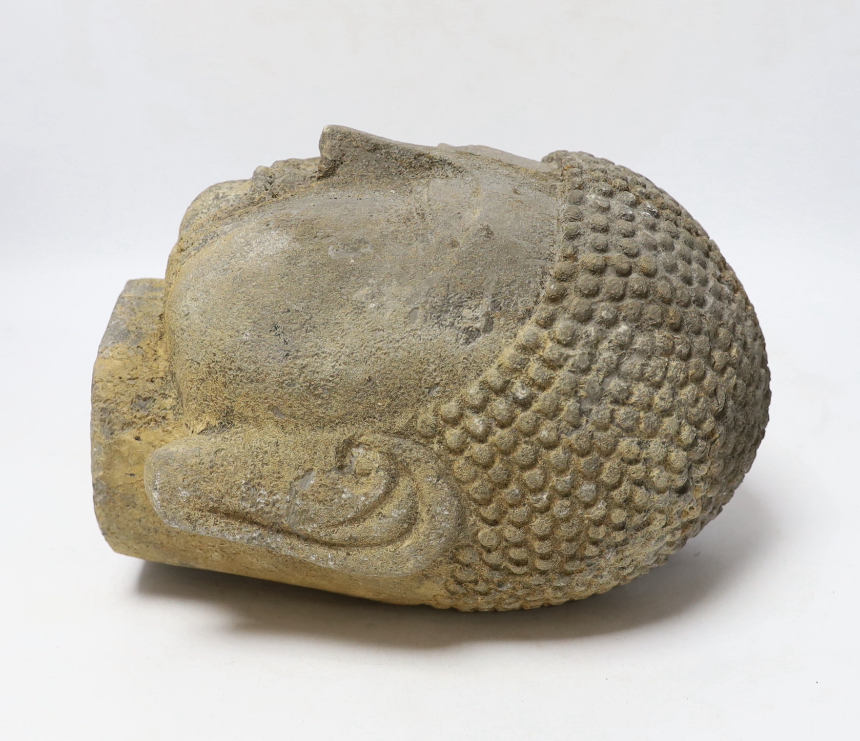 A reconstituted stone model of Buddha’s head, 25cm
